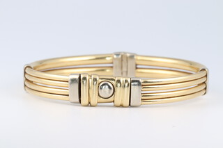 A 14ct yellow gold bangle 26.5 grams including a sprung interior, 60mm x 50mm 