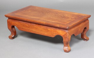A 20th Century rectangular Chinese carved hardwood Kang table, raised on cabriole supports 28cm h x 39cm w x 45cm d 