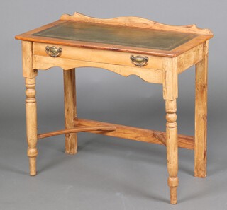 A Victorian pine side table with raised back and inset green leather writing surface, fitted a frieze drawer, raised on turned supports with shaped stretcher 74cm h x 82cm w x 41cm d 