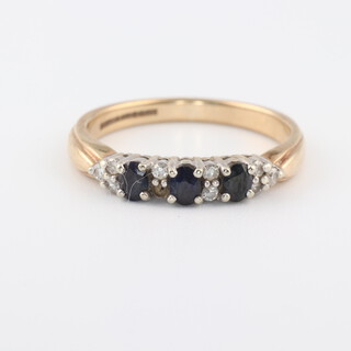 A 9ct yellow gold sapphire and diamond ring, the sapphires 0.30ct, the 9 diamonds 0.09ct, size N, 2.5 grams 
