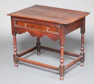 An 18th Century oak side table fitted a frieze drawer, raised on turned supports with box framed stretcher 69cm h x 82cm w x 58cm d 