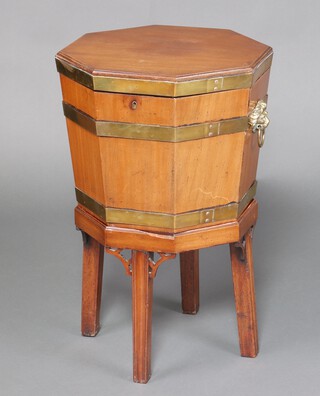 A Georgian octagonal bleached mahogany and brass banded cellarette with brass lion mask handles, raised on an associated detachable base 72cm h x 49cm w x 45cm d  