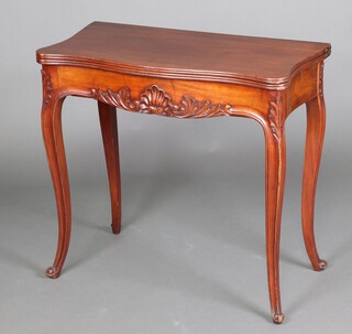 A 19th Century Continental mahogany tea table of serpentine outline, the apron with carved shell motif, raised on cabriole supports 76cm h x 83cm w x 41cm d 