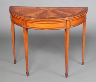 A Georgian Sheraton style inlaid and crossbanded mahogany demi-lune card table with inlaid shell decoration, raised on square tapered supports with spade feet 73cm h x 92cm w x 45cm d 