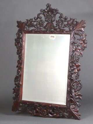 A Victorian rectangular bevelled plate wall mirror contained in a carved pierced oak frame, cast with fruit, swags and leaves throughout,   140 cm h x 95cm w