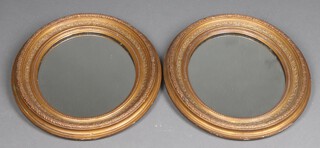 A pair of 19th Century rectangular bevelled plate mirrors contained in oval decorative gilt plaster frames 44cm h x 38cm w 