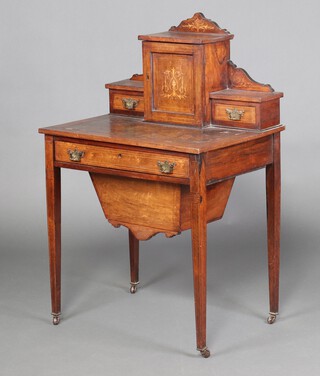 A Victorian inlaid rosewood writing table, the back with raised superstructure fitted shelves and a drawer enclosed by a  panelled door flanked by a pair of short drawers, the base with 1 long drawer, raised on square tapered supports 105cm h x 68cm w x 49cm d 