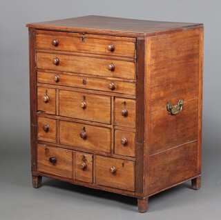 A 19th Century oak lined mahogany campaign style secretaire chest  (likely converted from a dressing chest - one drawer fitted a spigot) with reeded columns and brass carrying handles to the sides, the secretaire drawer fitted 3 pigeon holes above 1 long and 2 short drawers (drawer stops to the 2 short drawers missing), above 1 long and an arrangement of 3 long and 2 short drawers, all drawers with later turned handles, raised on square supports, 101cm h x 86cm w x 61cm d 