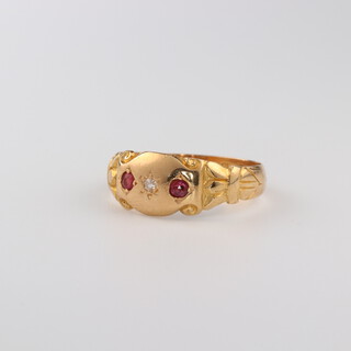 An 18ct yellow gold ruby and diamond ring, the 2 rubies 0.06ct, the diamond 0.02ct, size M, 3.3 grams 