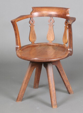 An Edwardian oak tub back revolving office chair with pierced vase shaped slats to the back, solid seat, raised on outswept supports 75cm h x 50cm w x 47cm d (seat 30cm x 30cm) 