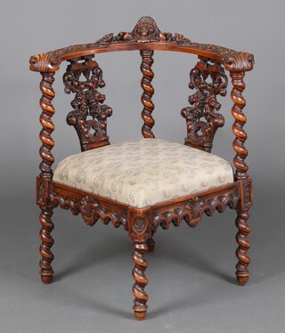 A Victorian deeply carved walnut tub back corner chair with lion mask and acanthus leaf carving and spiral turned columns, the 2 Gothic panels to the back carved rampant lions, having an upholstered drop in seat, raised on spiral turned supports 77cm h x 68cm w x 47cm d (seat 24cm x 24cm) 