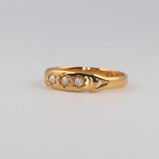 A 22ct yellow gold 3 stone diamond ring 0.09ct, size M 1/2, 2.6 grams 