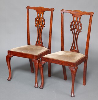 A pair of 1920's beech framed Chippendale style dining chairs with pierced vase shaped slat backs and upholstered drop in seats, raised on cabriole supports 100cm h x 50cm w x 42cm d (seat 23cm x 21cm) 