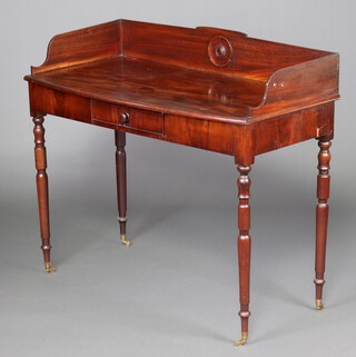 A Georgian mahogany bow front wash stand with 3/4 gallery fitted a drawer, raised on turned supports with brass caps and casters 96cm h x 109cm w x 50cm d 