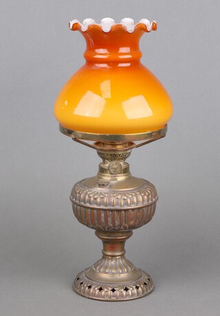 An American embossed gilt metal oil lamp reservoir with amber glass shade (no chimney) 38cm x 12cm 