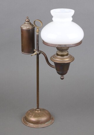 A Victorian brass adjustable desk oil lamp with opaque glass shade, raised on a circular foot 46cm x 14cm 