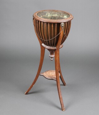 An Edwardian style circular pierced and inlaid mahogany planter with metal liner, raised on outswept supports 84cm h x 36cm diam. 