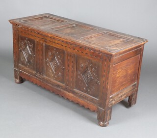 A 17th/18th Century oak coffer of panelled construction, the lid fitted a centre panel flanked by 2 sliding panels, the front inlaid with ebony and light oak chequering above 3 diamond carved panels 69cm h x 129cm w x 52cm d 