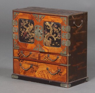 A Japanese lacquered table top cabinet, fitted 6 drawers with polished metal swan drop handles, enclosed by a pair of panelled doors decorated birds amidst branches, the base fitted 2 short and 1 long drawer 30cm h x 29cm w x 14cm 
