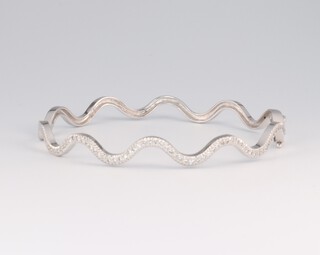 An 18ct white gold diamond set wavy bangle, 5cm diam., approx. 0.5ct of diamonds, 11.6 grams 