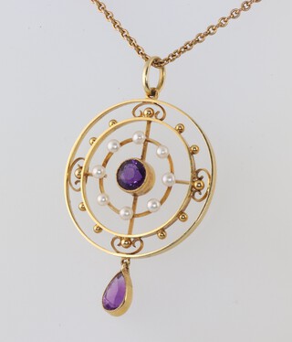 A 9ct yellow gold chain, 36cm, with an Edwardian circular 15ct yellow gold amethyst and seed pearl pendant, gross weight 5.6 grams 
