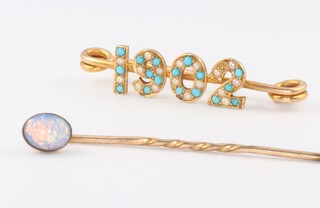A yellow gold, testing as 14ct, turquoise set 1902 brooch 2.6 grams and an opal set tie pin 0.7 grams