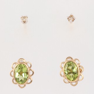 A pair of 18ct yellow gold diamond ear studs 0.03ct, 0.6 grams and a pair of peridot 9ct earrings 1.3 grams 