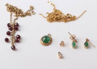 A 9ct yellow gold garnet set necklace 40cm, a 9ct pendant and a pair of emerald set ear studs, gross weight 6.7 grams 