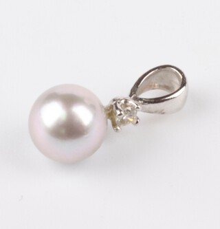 A 14ct white gold cultured pearl and diamond pendant, the pearl 7mm, the diamond 0.03ct, 0.9 grams 