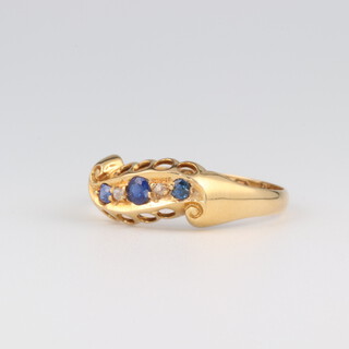 An 18ct yellow gold diamond and sapphire ring, the sapphires 0.13ct, the diamonds 0.01ct, size P, 2.1 grams