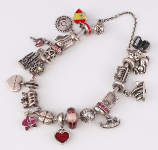 A Pandora bracelet with 17 silver charms, gross weight 82 grams 