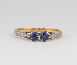An 18ct yellow gold sapphire and diamond ring, the 2 sapphires 0.30ct, the diamonds 0.02ct, size P, 2.7 grams 