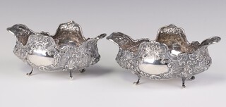 A pair of Victorian repousse silver dishes decorated with scrolls and flowers, Glasgow 1895, 14cm, maker George Edward & Sons, 238 grams 
