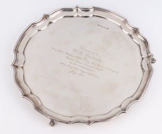 A silver salver with Chippendale rim and scroll feet with presentation inscription Sheffield 1965, 25cm, 458 grams 