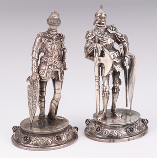 A pair of Continental silver 925 figures of standing knights with articulated visors and cabochon garnet bases stamped KL, 11cm, 356 grams 