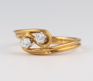 An 18ct yellow gold 2 stone cross-over diamond ring, 0.30ct, size Q, 3.8 grams
