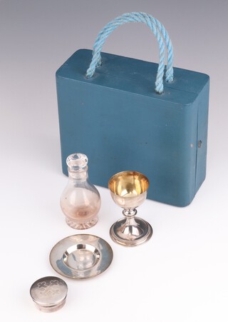 A Victorian 4 piece travelling silver communion set comprising challis, paten, pyx and glass holy water bottle, cased, London 1874, weighable silver 122 grams 