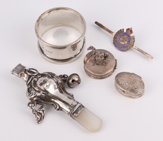 A silver rattle with mother of pearl teether, napkin ring, 2 pill boxes, sugar tongs and a brooch, 49 grams 