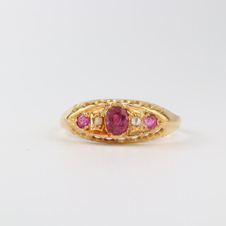 An 18ct yellow gold ruby and diamond ring, the 3 rubies 0.30ct, the diamonds 0.04ct, size N, 1.6 grams 