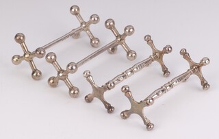 Two pairs of silver knife rests London 1849 and Birmingham 1913, 138 grams 