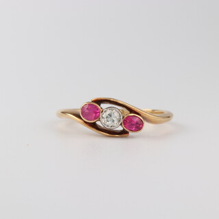 An 18ct yellow gold ruby and diamond ring, the 2 rubies 0.20ct, the diamond 0.10ct, size L, 2.3 grams
