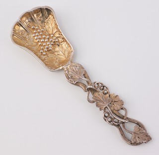 A cast silver caddy spoon with vinous decoration Birmingham 1975, 11.5cm, 34 grams