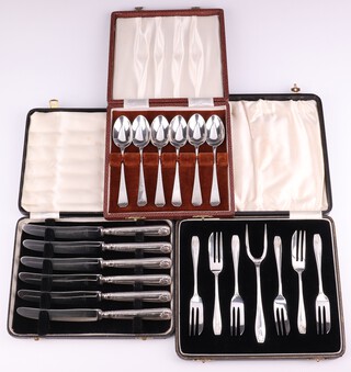 A set of 6 silver engraved teaspoons Sheffield 1924 and 6 cake forks Birmingham 1934, cased, 200 grams and a set of 6 silver handled butter knives
