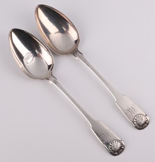 A pair of George IV silver fiddle pattern serving spoons with shell terminals and engraved monogram, Newcastle 1824, maker John Walton, 142 grams 