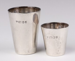 A silver tot of plain form London 1978, 6.5cm and a smaller ditto 4.5cm, 124 grams