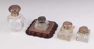 A silver mounted glass inkwell Birmingham 1920, 4.5cm, 2 others with silver mounts and a silver mounted toilet bottle 