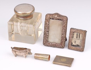 An Edwardian novelty silver pin cushion in the form of a standing pig 5cm, 2 small silver photo frames, a cheroot collar, ink well and a plated vesta 