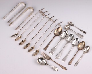 A pair of George III silver sugar nips and a collection of spoons, 320 grams 