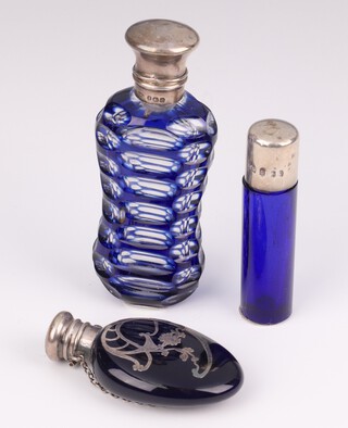 A Victorian silver faceted blue and clear glass scent, rubbed marks, 9cm, a circular ditto 7cm, an overlaid ditto 6.5cm 