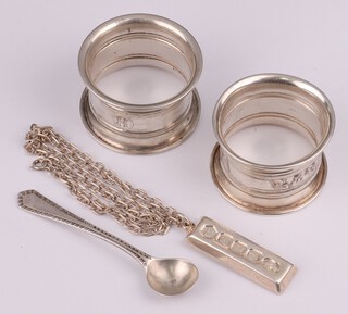 A 1977 silver ingot and chain, 2 napkin rings and a spoon 67 grams 